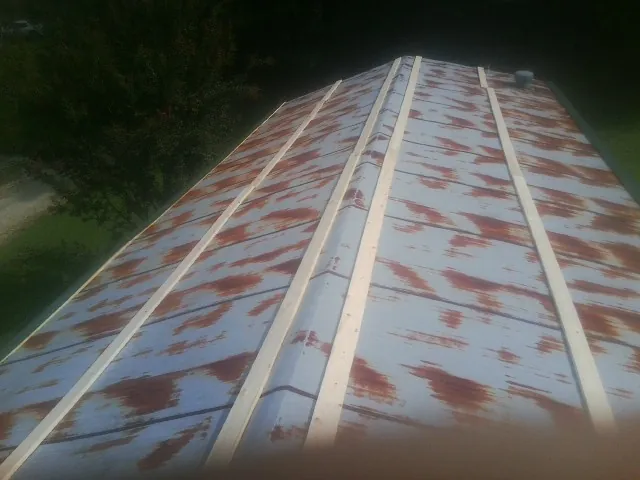 Rusted metal roof panels with new wood purlins before replacement — Storm Damage Roof Repair in Frankfort by Roofing Brothers